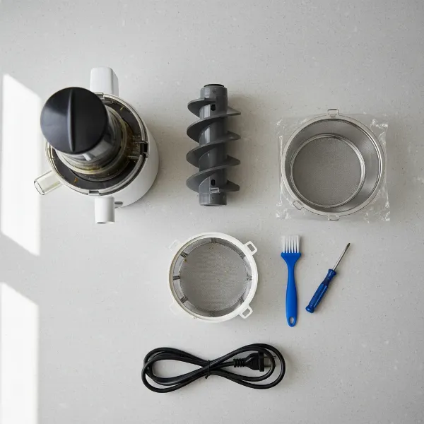 Essential tools and a disassembled juicer laid out for screen replacement.