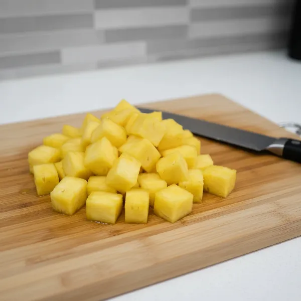 Freshly peeled pineapple chunks ready for juicing, highlighting ease and smooth juice.